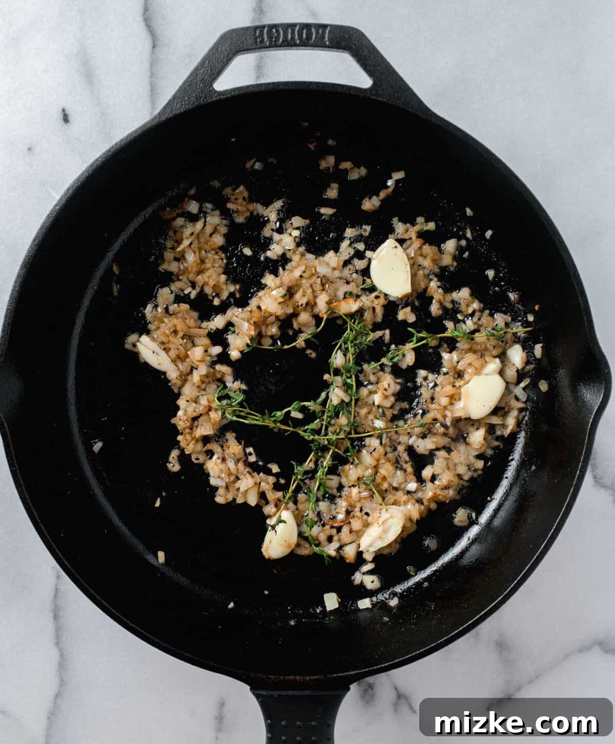 Unlocking Oyster Mushroom Potential 6 Fresh sprigs of thyme gracefully added to a cast iron skillet, joining a mix of sautéing garlic and onions, creating a rich aromatic foundation.