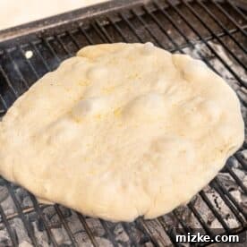 pizza dough on top of an outdoor grill