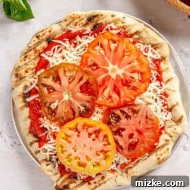 sliced heirloom tomatoes on top of mozzarella cheese