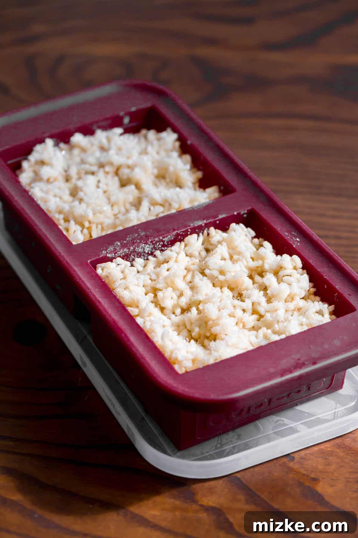 The Secret to Perfectly Fluffy White Rice 6 Perfectly cooked white rice, portioned and frozen in burgundy silicone Souper Cube trays, showcasing an efficient meal prep strategy.
