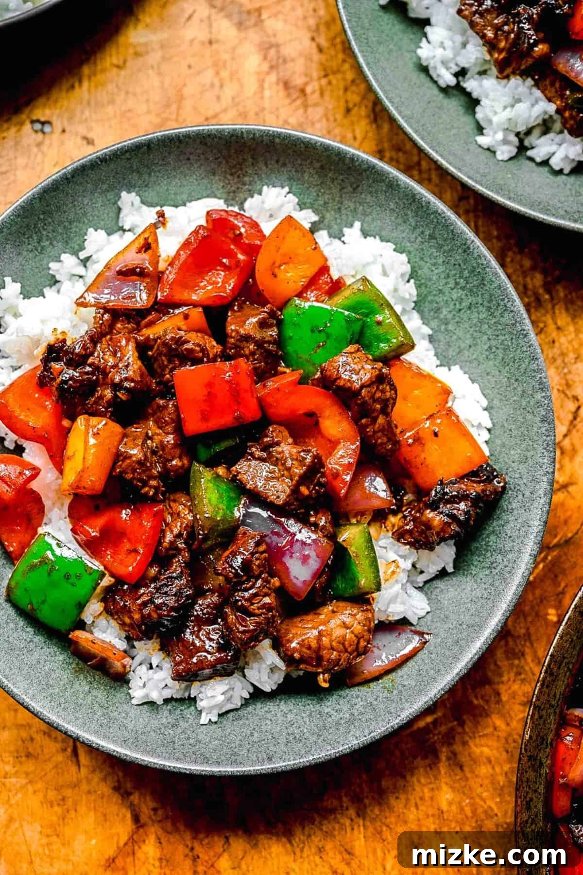 Secrets to Perfectly Fluffy Jasmine Rice 7 Bo Luc Lac, also known as Vietnamese Shaking Beef, served elegantly over fluffy white rice in individual bowls.