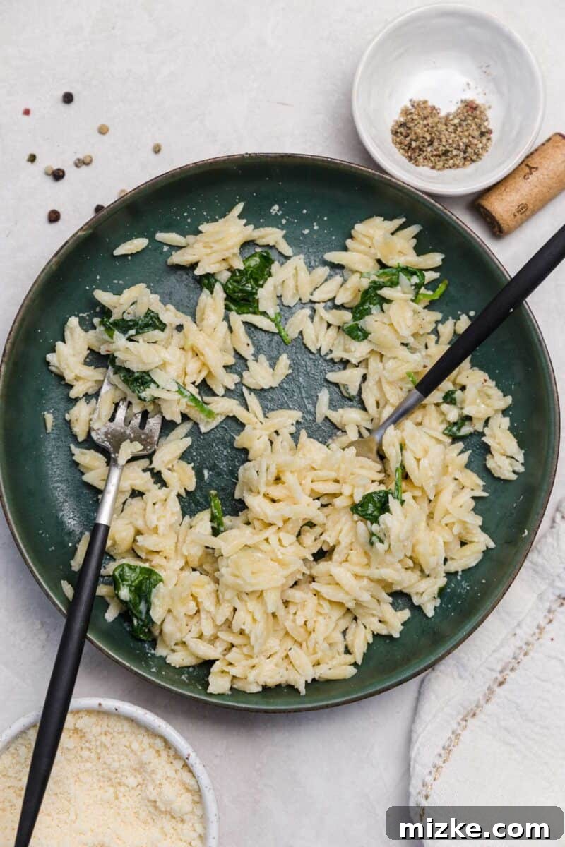 Velvety Spinach Parmesan Orzo 7 Overhead shot of a full pot of creamy Parmesan and spinach orzo, beautifully garnished and ready to be served family-style.