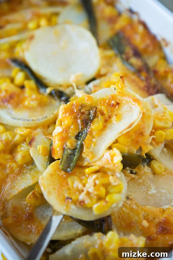 Layers of Flavor: Poblano Potato Gratin Poblano Potato Gratin, showcasing layers of sliced potatoes, roasted poblano peppers, and sweet corn, topped with melted cheese.