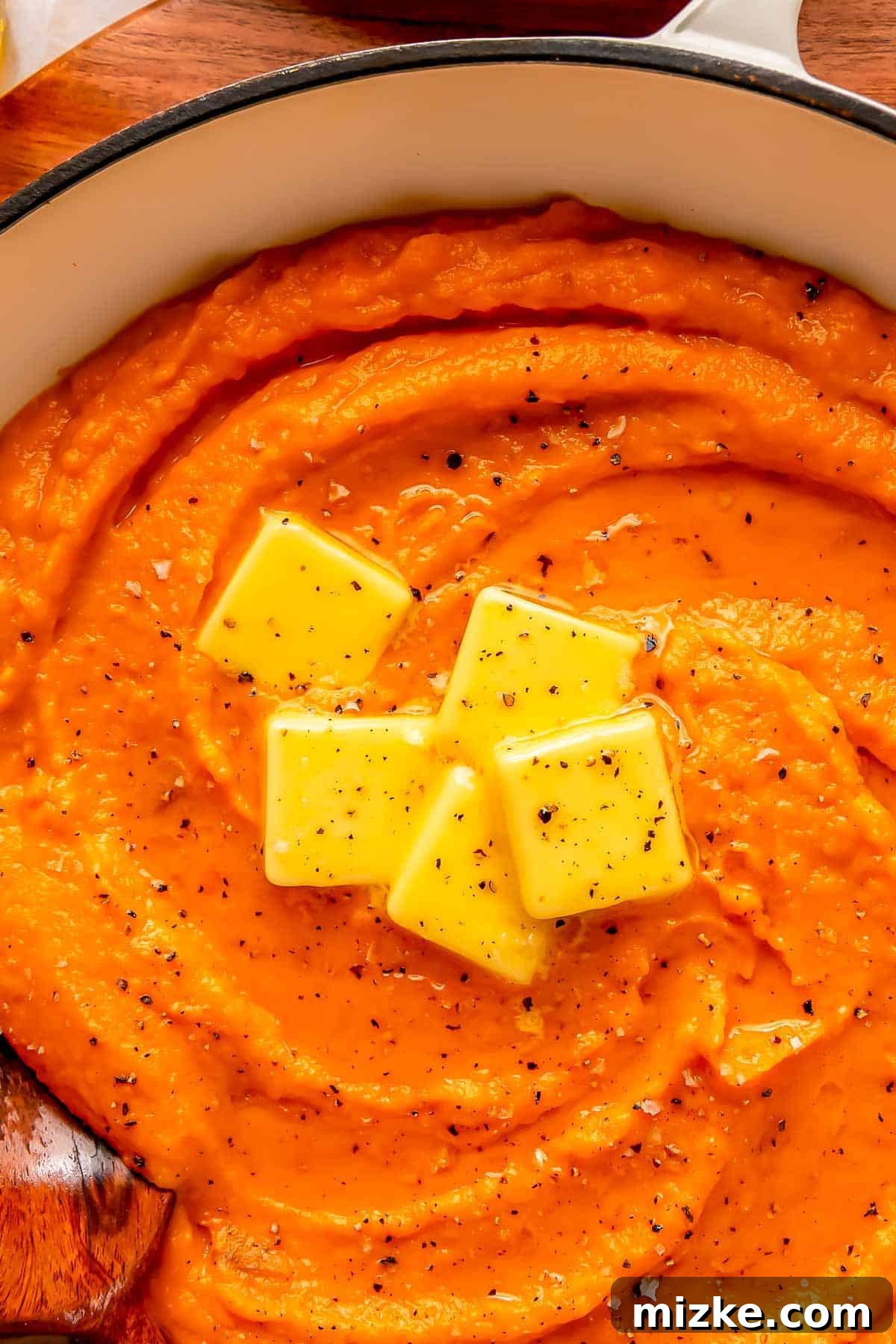 Whipped Sweet Potatoes 3 5 pads of butter on top of mashed sweet potatoes with fresh black pepper on top