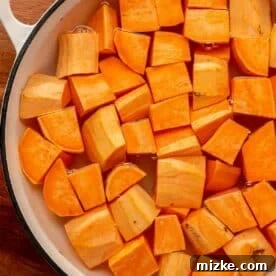 cubed sweet potatoes in a pot of water
