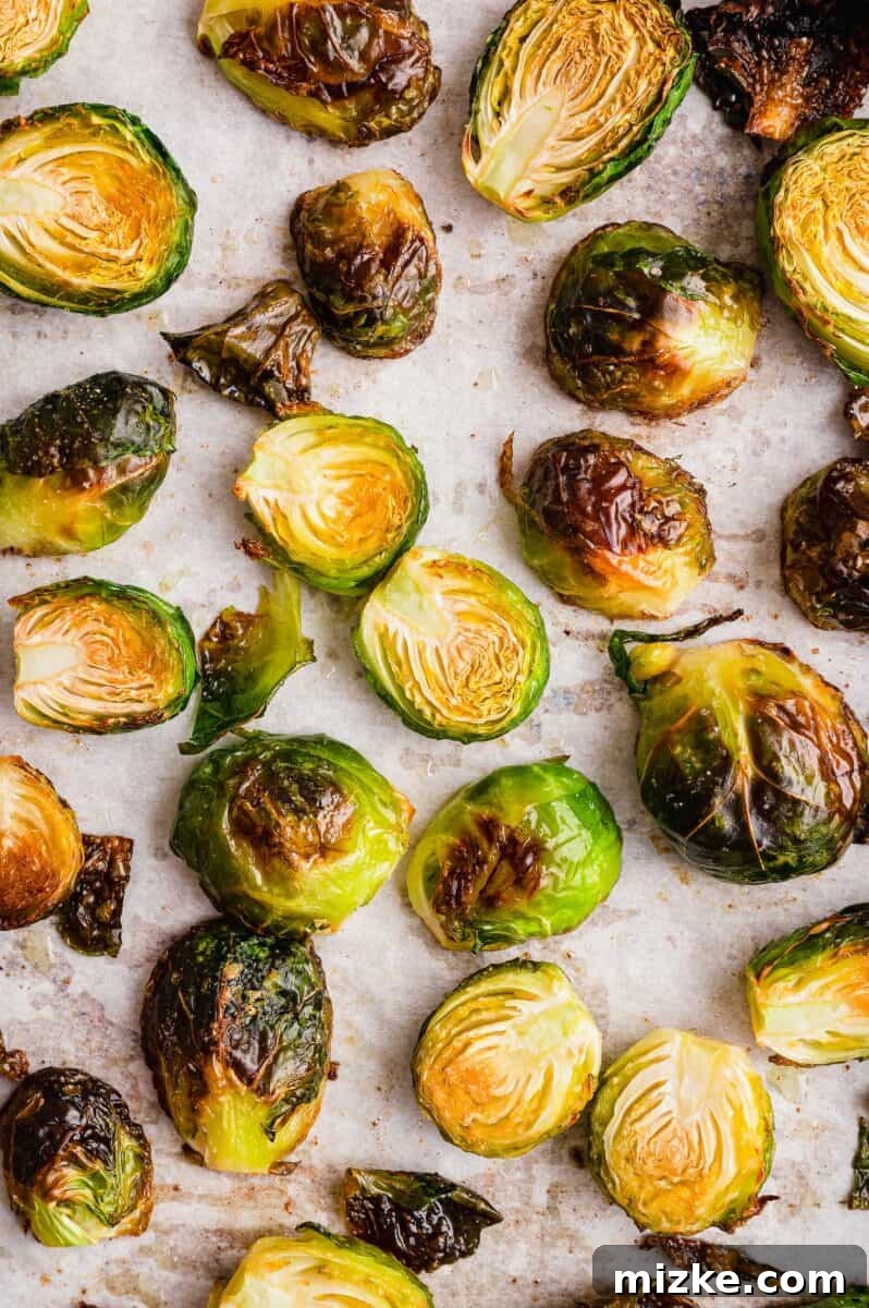 Crispy Garlic Roasted Brussels Sprouts 4 Close-up image of individual roasted Brussels sprouts, showing their distinct browned and slightly charred exterior, indicating perfect crispness.