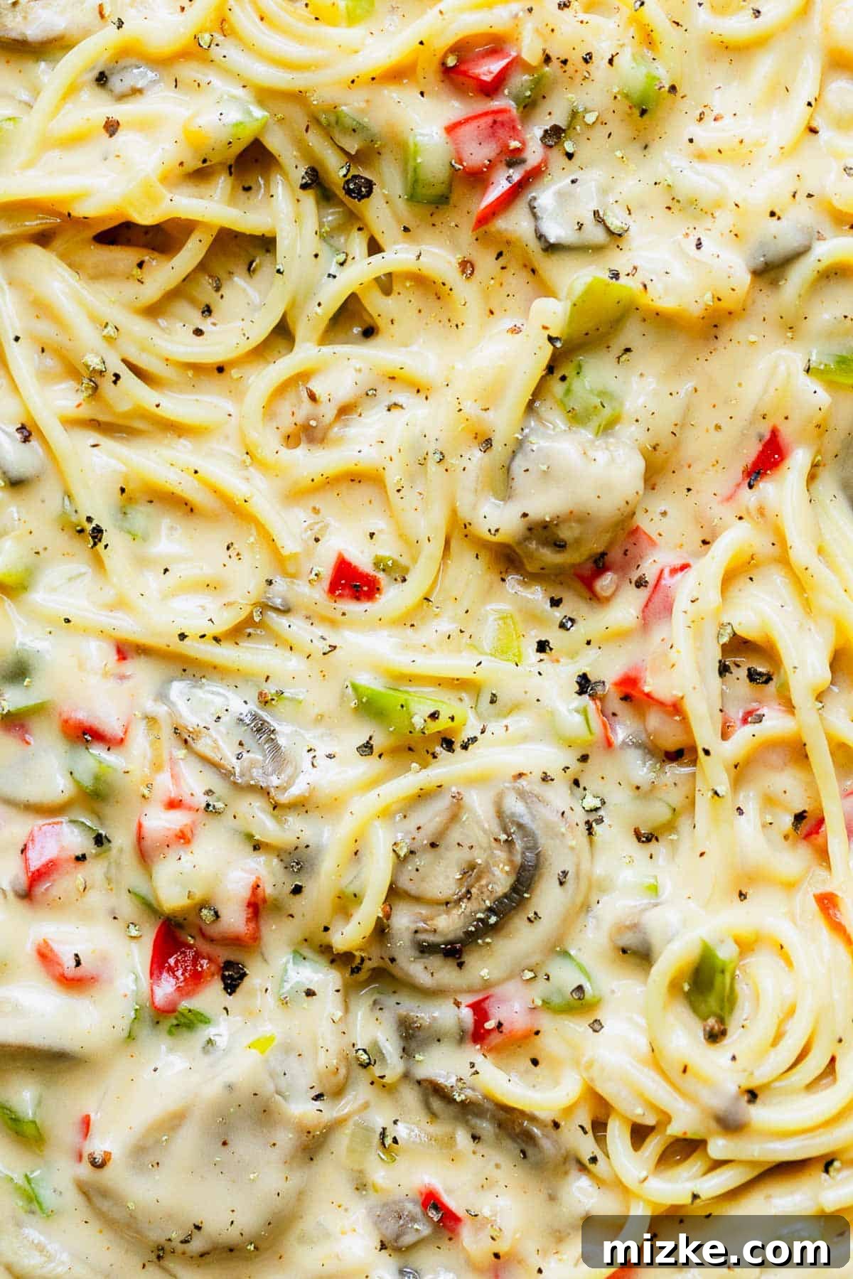 Cheesy Spaghetti Bake 5 Spaghetti casserole mixture topped with fresh black pepper before baking.