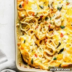 Inside of baked spaghetti casserole next to a grey linen towel, representing the final dish.