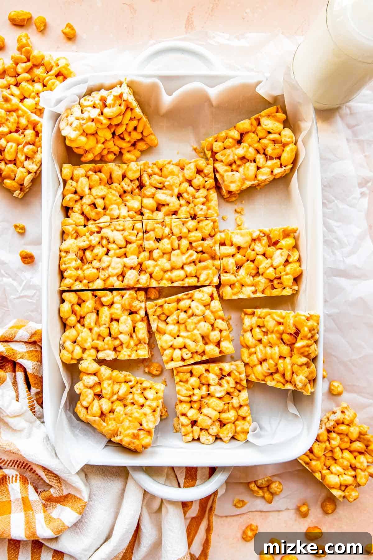 Wholesome Grain Bars 11 Bars have been precisely cut into individual portions within the casserole dish, ready for serving.
