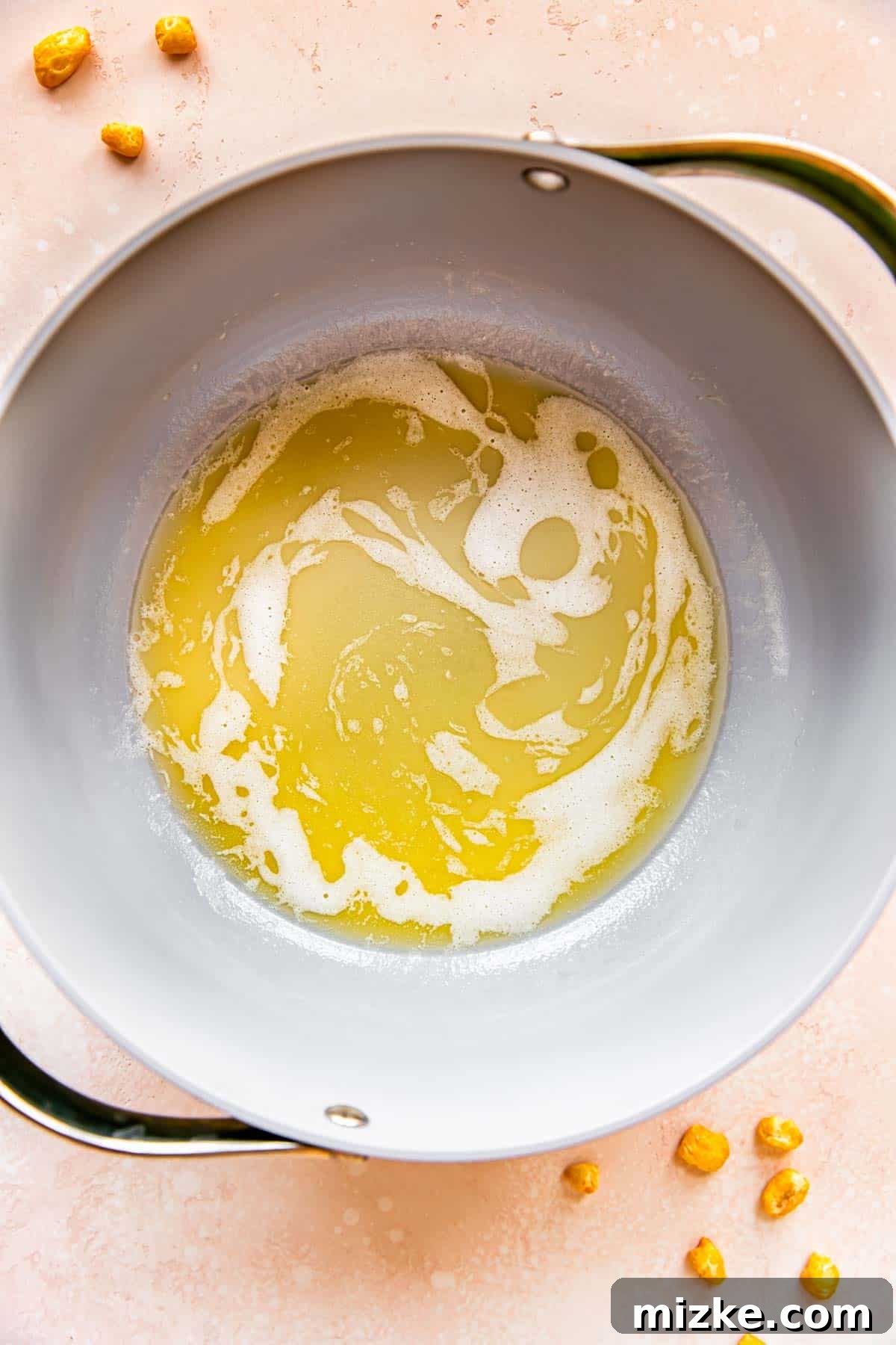 Wholesome Grain Bars 4 Butter is melting in a large pot over medium-high heat on a stovetop.