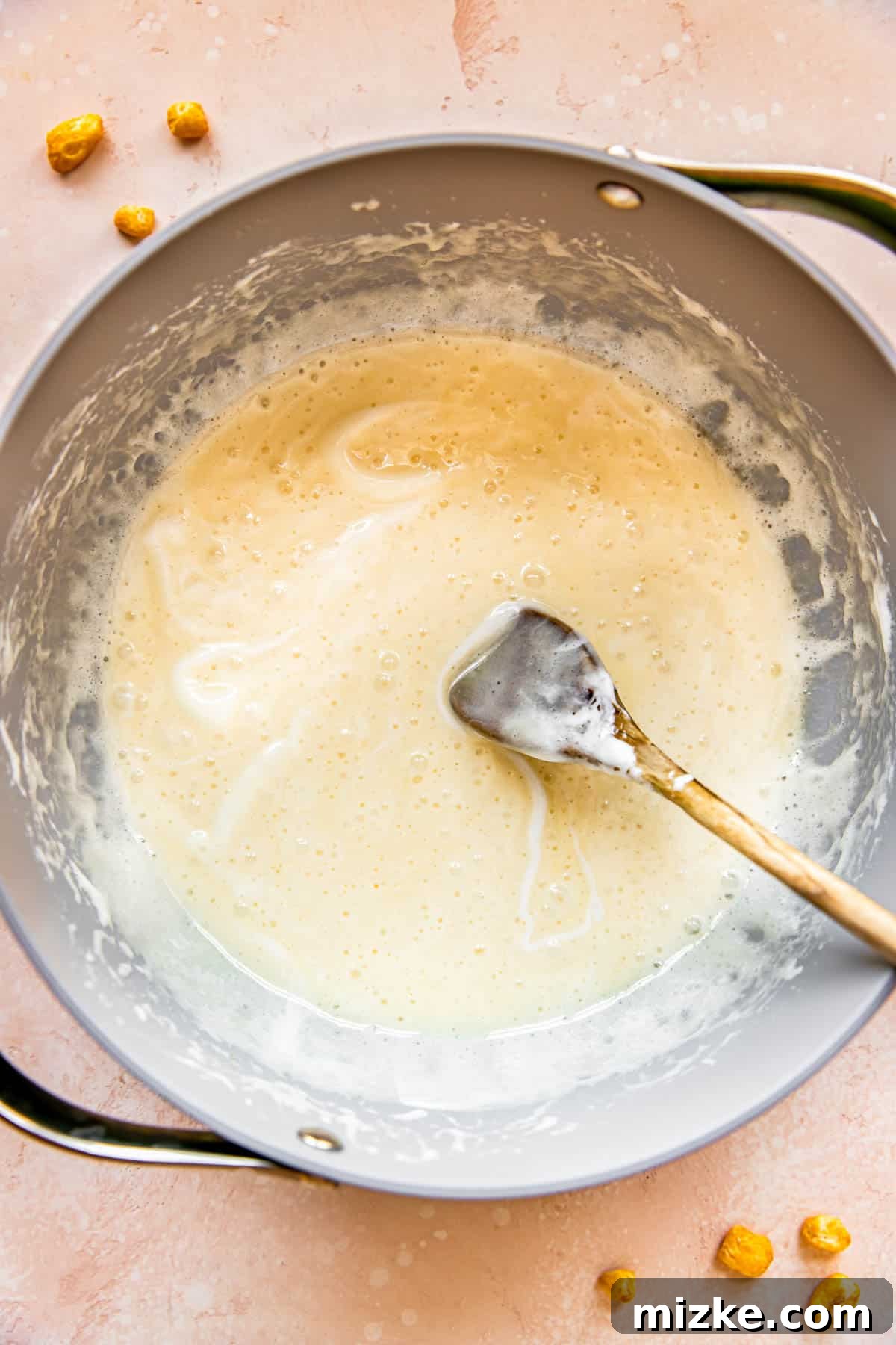Wholesome Grain Bars 6 Marshmallows have fully melted and are smoothly combined with butter in a pan, creating a gooey mixture.