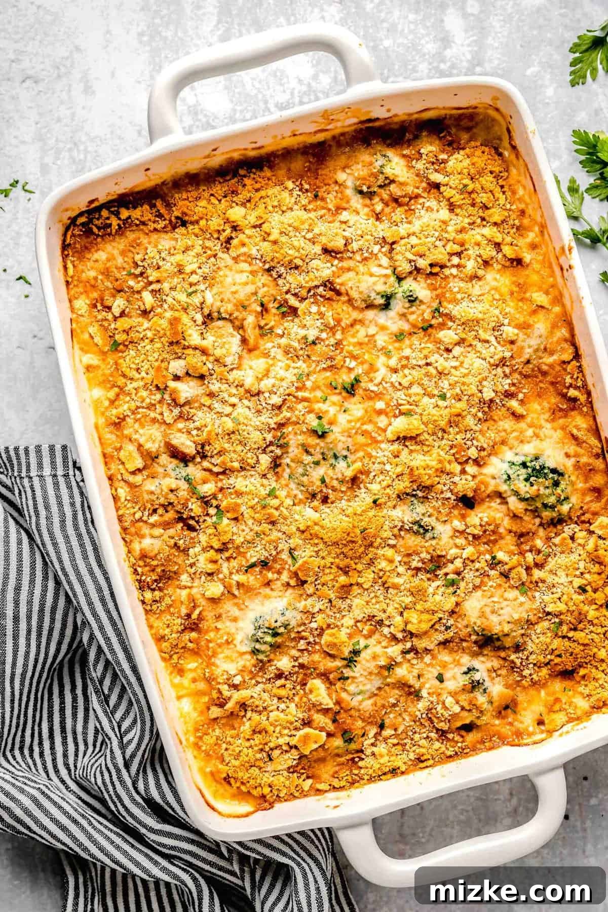 This cheesy chicken broccoli rice casserole is topped with buttery Ritz crackers and comes together so quickly. It's a perfect weeknight meal. Chicken broccoli rice casserole in a casserole dish.