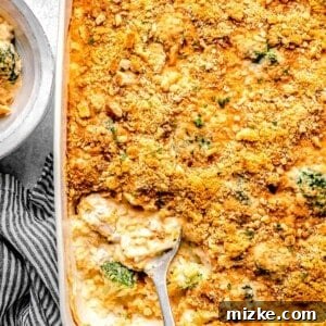 Chicken broccoli rice casserole in a casserole dish with a serving spoon.