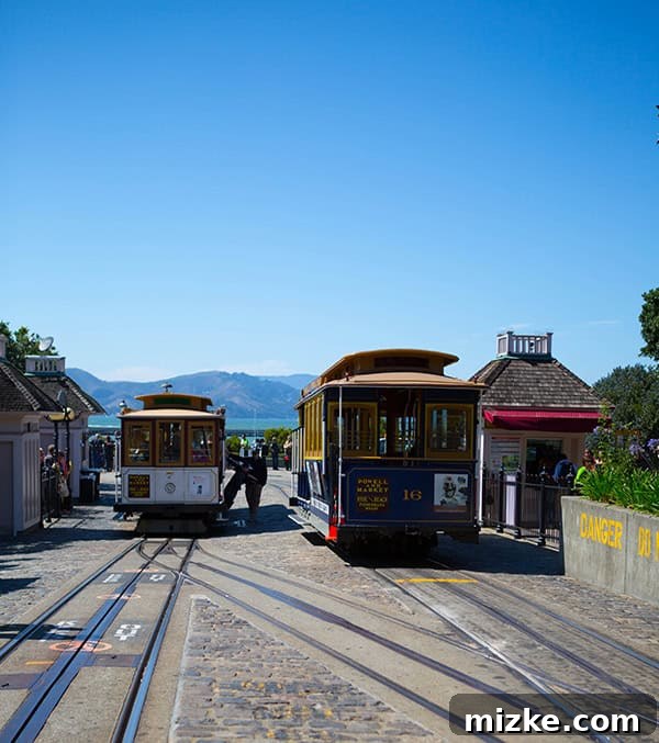 San Francisco's Ghirardelli Square offers iconic views and starting point for cable car adventures. San Francisco cityscape view from Ghirardelli Square, showing distant Golden Gate Bridge and cable cars.