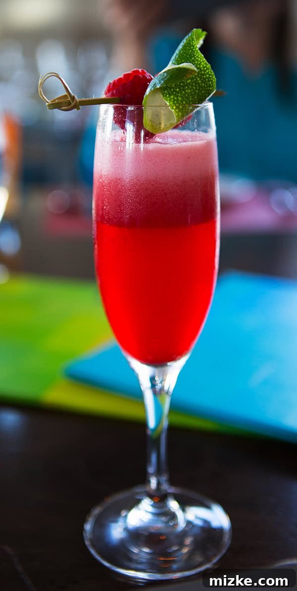 The Scarlet: A refreshing pisco sour cocktail at La Mar. Two beautifully presented Scarlet cocktails, garnished with raspberries.