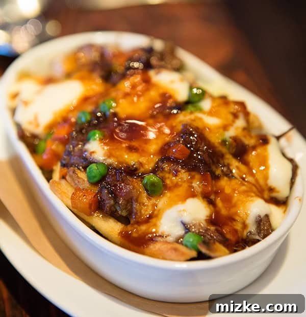 Wayfare Tavern's innovative oxtail poutine. A rich and savory oxtail poutine with melted cheese and gravy.