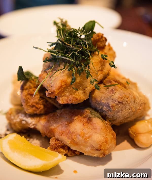 Buttermilk-brined fried chicken: A surprising delight at Wayfare Tavern. Perfectly fried buttermilk chicken pieces on a rustic plate.