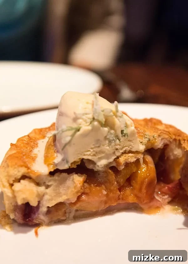 A truly unforgettable dessert experience. Close-up of the exquisite peach pie, showing its delicious layers.