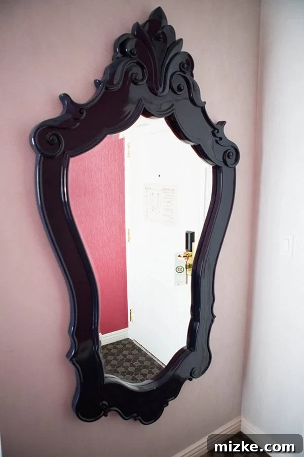 Beautiful details make the Kimpton Hotel Monaco suite feel luxurious. Stylish decorative pillows and an ornate mirror in the hotel suite.