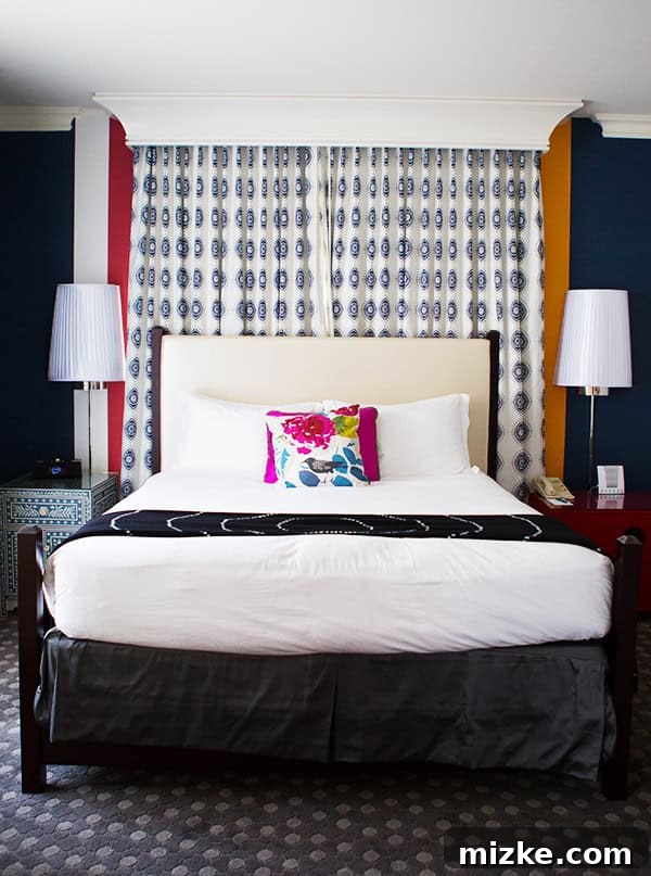 A comfortable and serene bedroom at Kimpton Hotel Monaco. A luxurious and inviting bed with crisp white linens and elegant headboard.