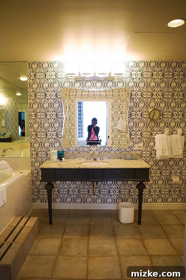 The expansive and elegant bathroom of the suite. A spacious and luxurious hotel bathroom with a large bathtub.