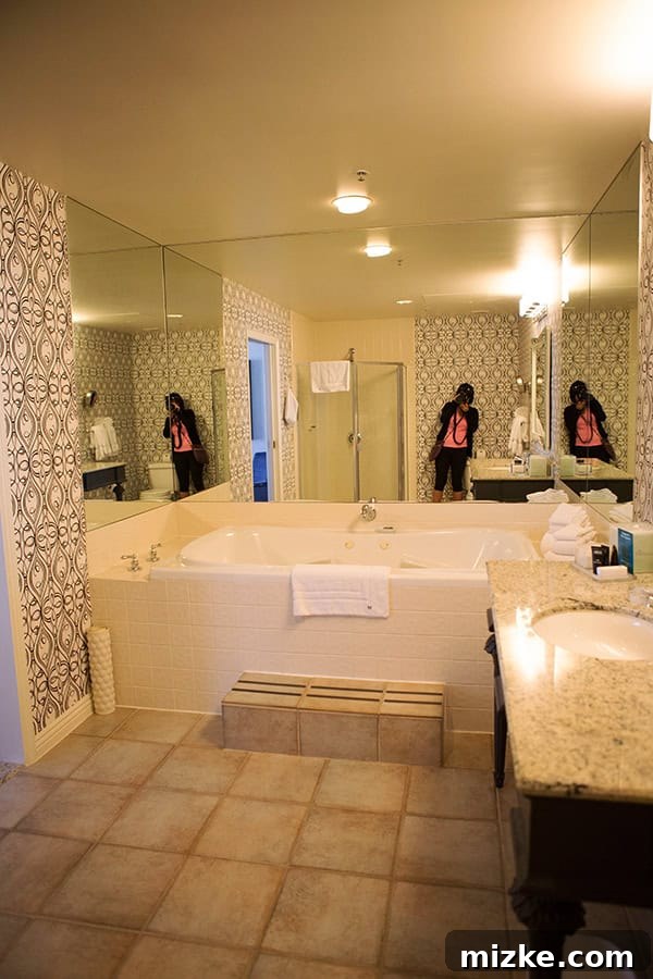 A luxurious and well-appointed bathroom for ultimate comfort. Another view of the large hotel bathroom, showcasing its modern amenities.