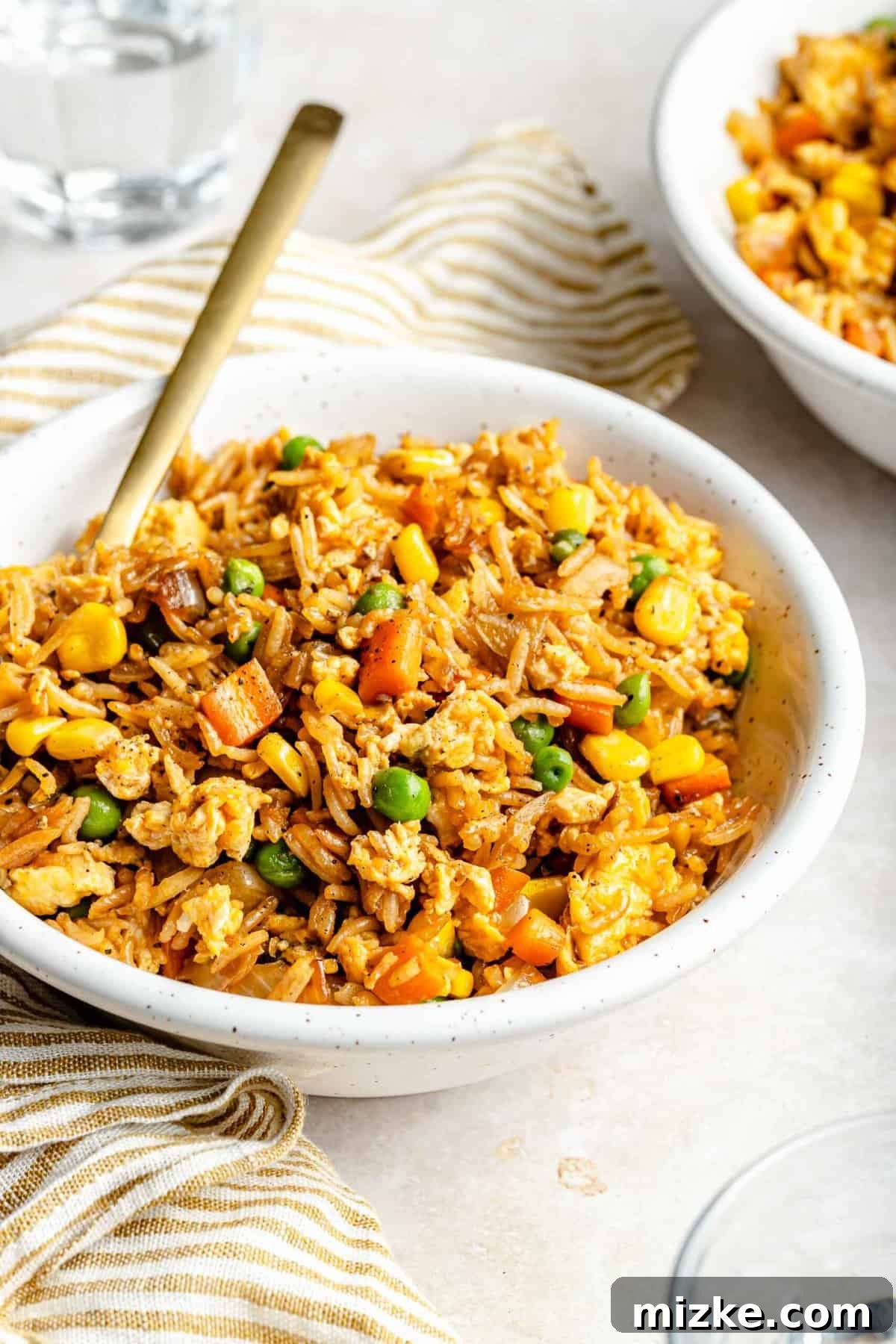 Perfectly cooked vegetable fried rice featuring tender veggies, fluffy eggs, and savory rice. Vibrant vegetable fried rice served in a bowl, garnished with fresh green onions.