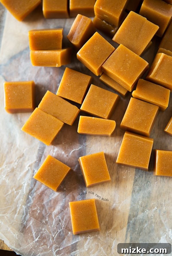 A vibrant display of homemade apple cider caramels, showcasing their beautiful amber hue and soft, chewy texture against a warm, inviting backdrop.