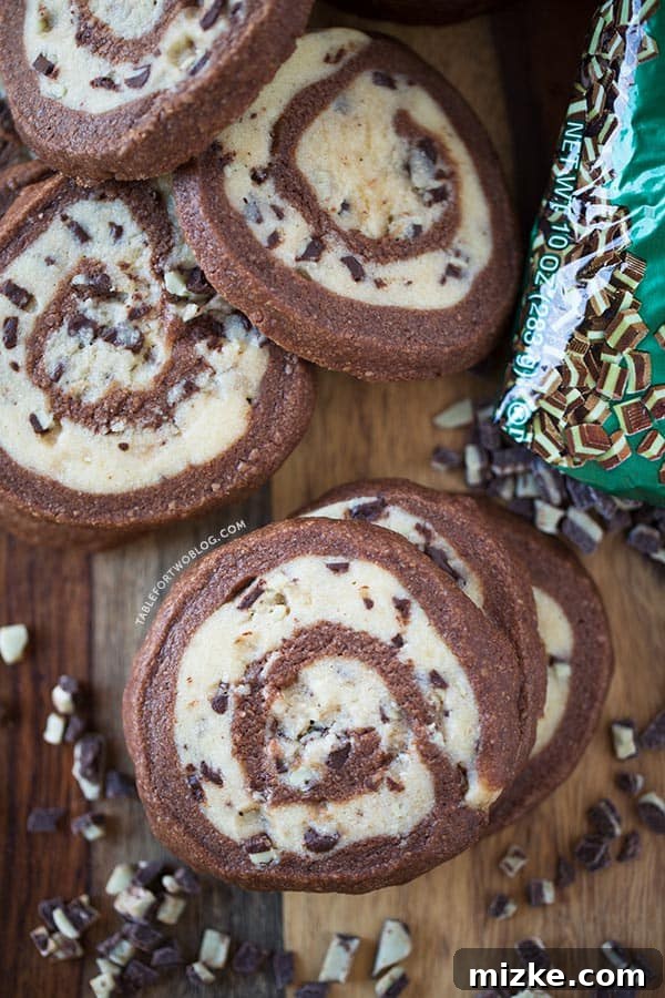 The Art of Pinwheel Cookie Baking Close-up of a perfectly baked Chocolate Mint Pinwheel Cookie showcasing its intricate two-tone swirl.