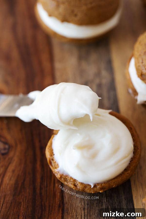 Mini gingerbread whoopie pies are the perfect little treat for the holiday season! Make this for all your festive gatherings! A close-up shot of mini gingerbread whoopie pies, highlighting their moist texture and creamy filling, perfect for holiday feasts.