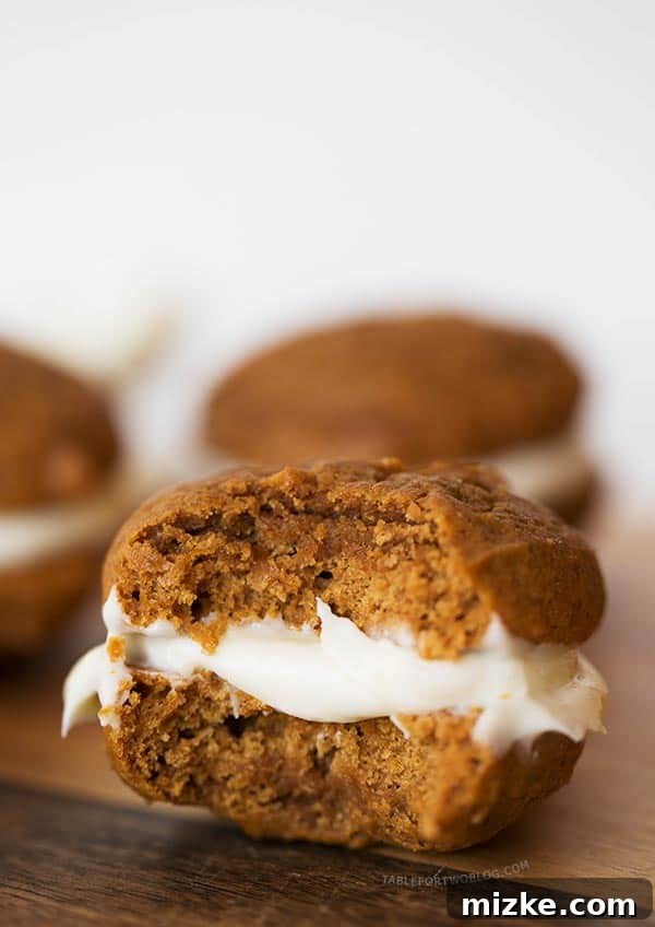 Mini gingerbread whoopie pies are the perfect little treat for the holiday season! Make this for all your festive gatherings! Stacked mini gingerbread whoopie pies showcasing the creamy lemon cream cheese filling. An ideal sweet treat for holiday dessert tables.