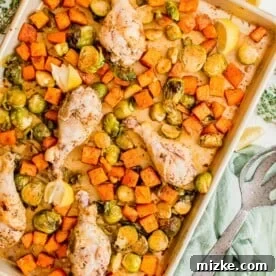20 Quick Chicken Dinners for Busy Weeknight Meals 16 lemon pepper drumsticks and roasted vegetables on a rimmed metal sheet pan next to fresh lemon slices