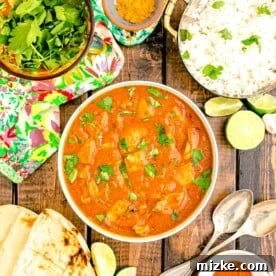 20 Quick Chicken Dinners for Busy Weeknight Meals 19 rice, cilantro and limes are placed around a bowl filled with butter chicken.