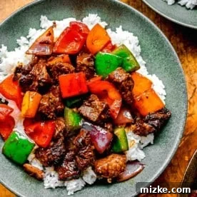 Bo luc lac served over rice in bowls.