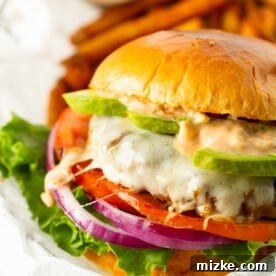 california burger between two brioche buns with burger sauce and avocado
