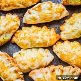 Overhead view of baked Chinese curry pockets on sheet pan