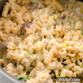 up close image of spiral pasta with creamy boursin cheese throughout