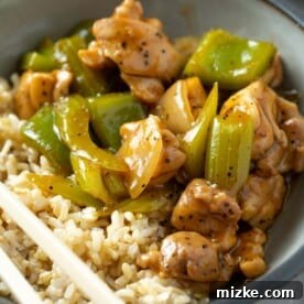 black pepper chicken in a bowl with brown rice
