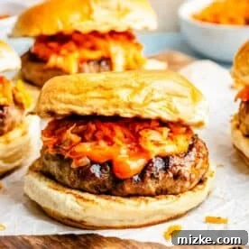 bulgogi kimchi burger topped with kimchi and gochujang mayo on parchment paper