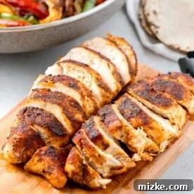 sliced air fryer blackened chicken on a wooden cutting board