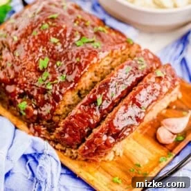 sliced meatloaf on a wooden plate